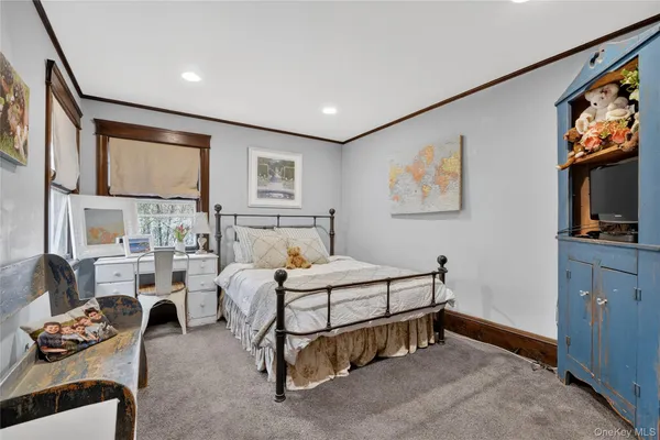 a bedroom with furniture and a flat screen tv