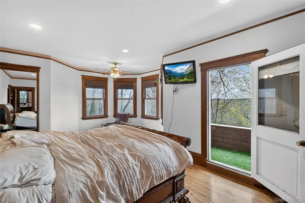 a bedroom with a large bed and a large window