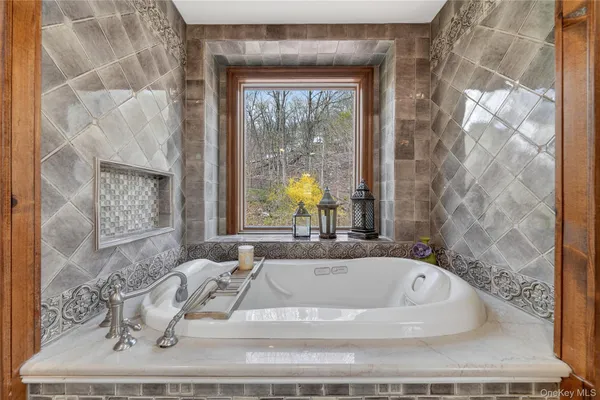 a bath tub sitting in a bathroom next to a window