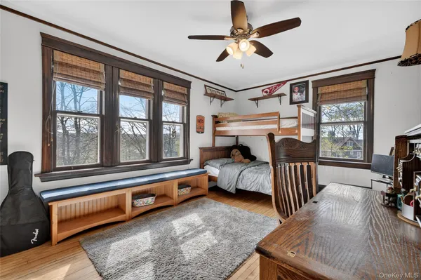 a bedroom with furniture and a large window
