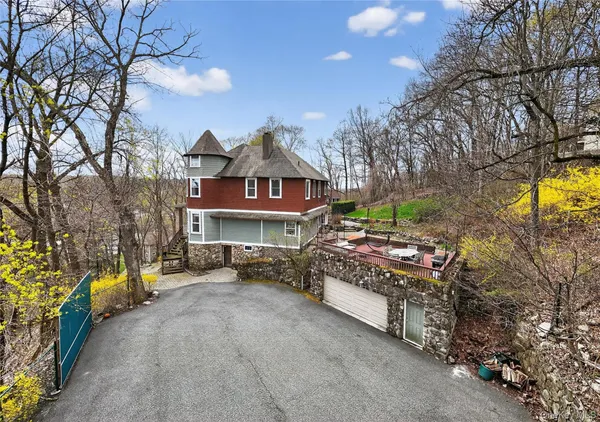 a view of a house with a large trees and a yard