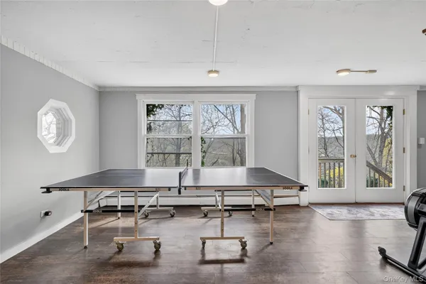 a view of a workspace with furniture and wooden floor