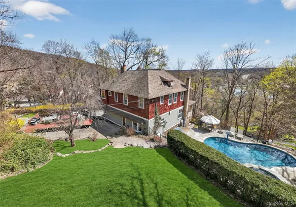 a view of a house with a yard and sitting area