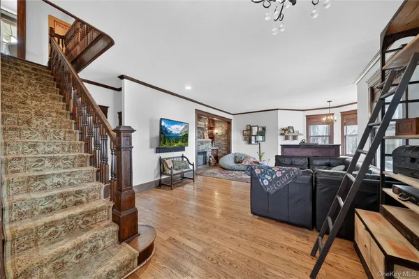 a living room with furniture or couch and a wooden floor