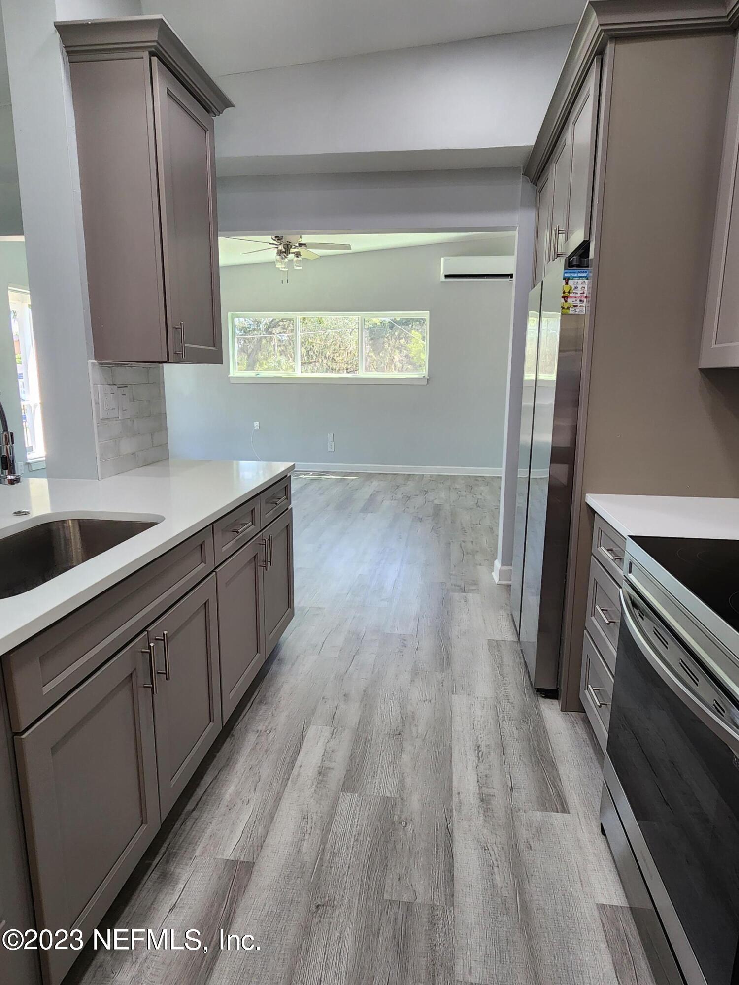 1306 Morgana Road Jacksonville, FL 32211 - Photo 17 of 33 a kitchen with granite countertop wooden floors and stainless steel appliances