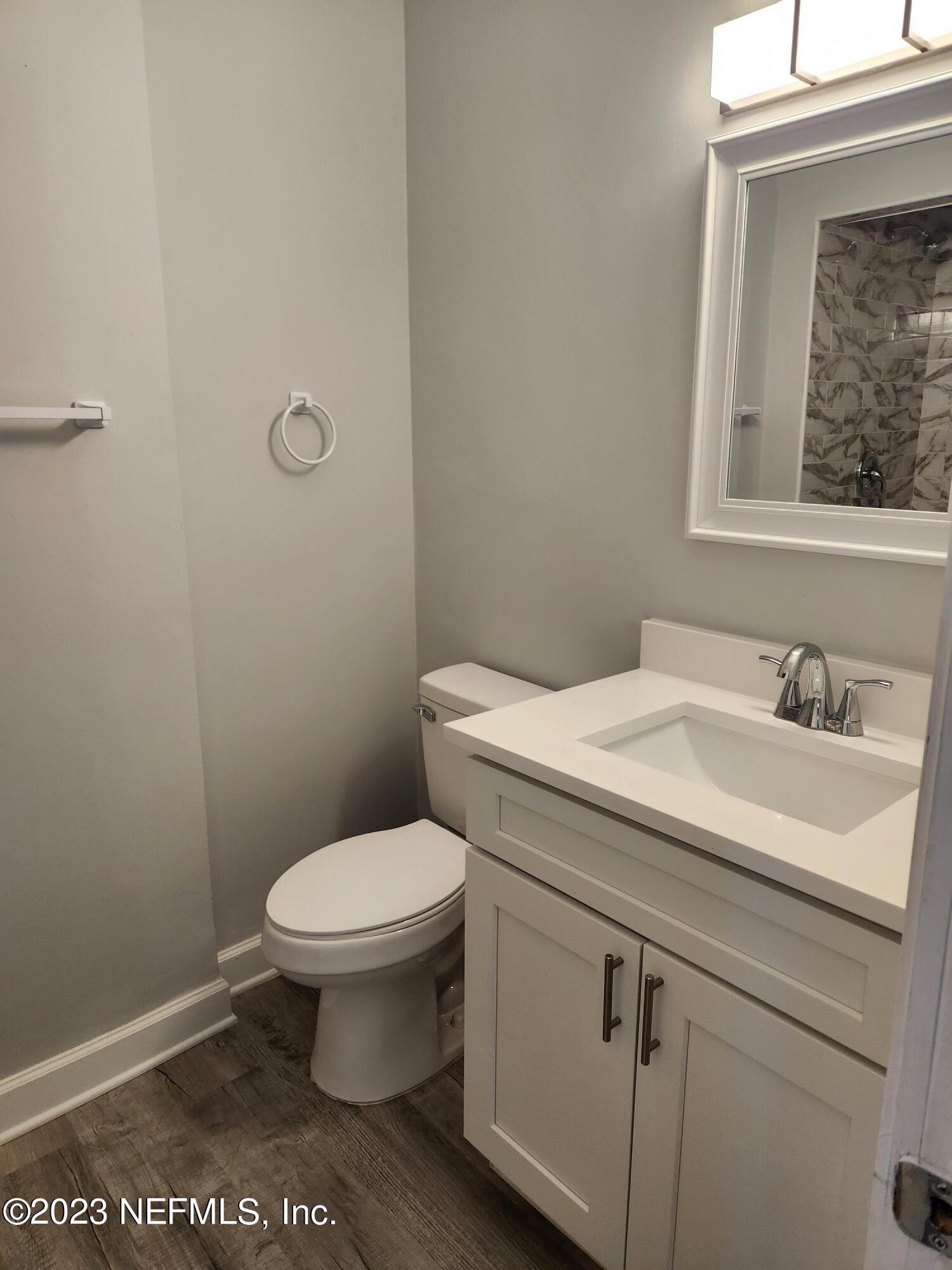 1306 Morgana Road Jacksonville, FL 32211 - Photo 23 of 33 a bathroom with a sink a toilet and a mirror
