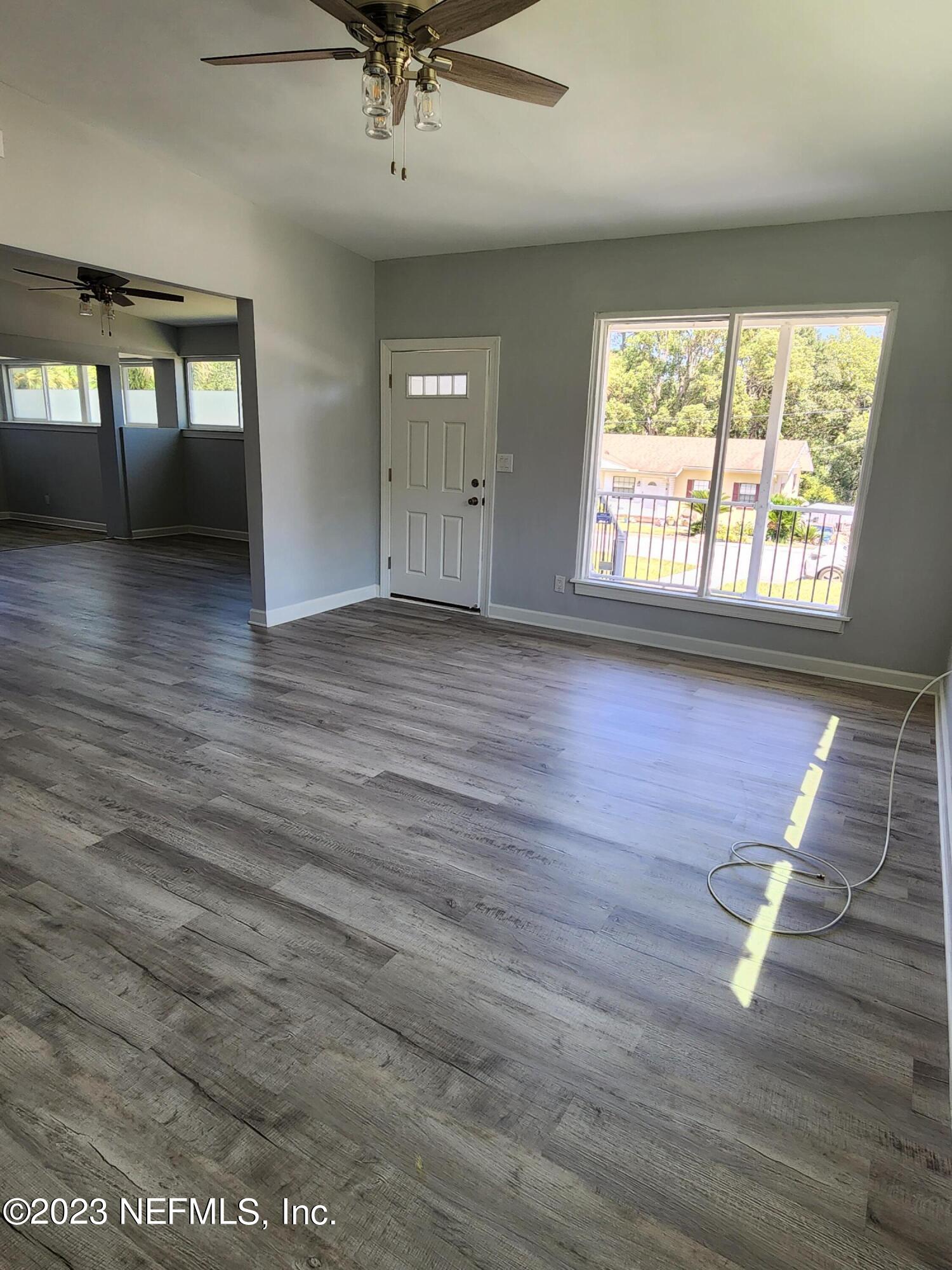 1306 Morgana Road Jacksonville, FL 32211 - Photo 6 of 33 an empty room with wooden floor and windows