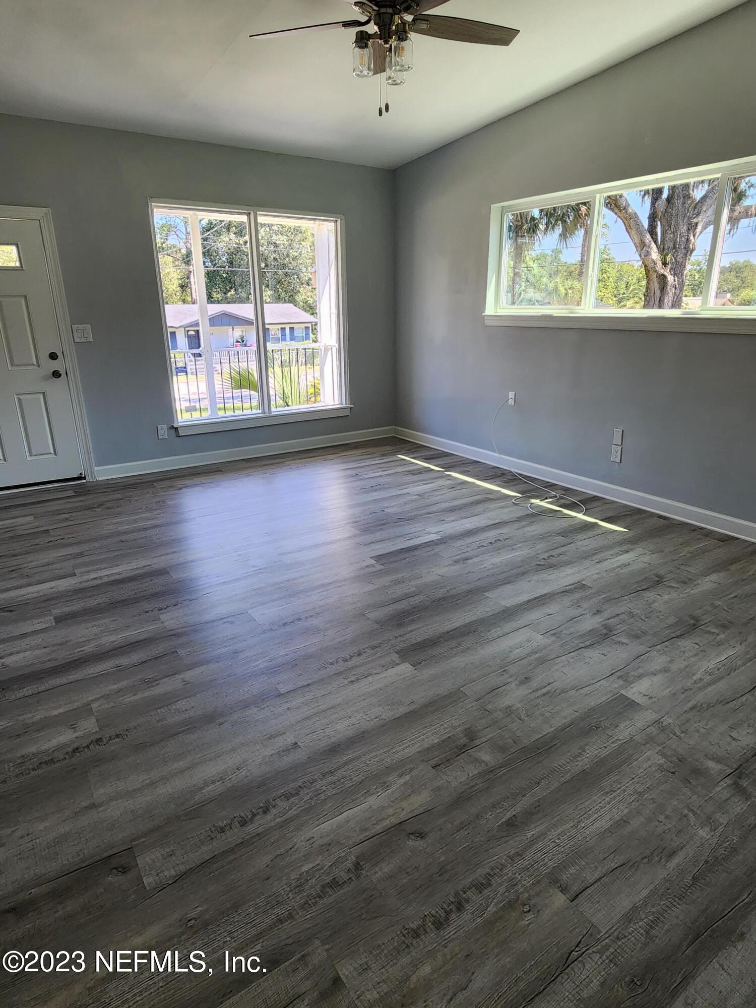 1306 Morgana Road Jacksonville, FL 32211 - Photo 7 of 33 an empty room with wooden floor and windows