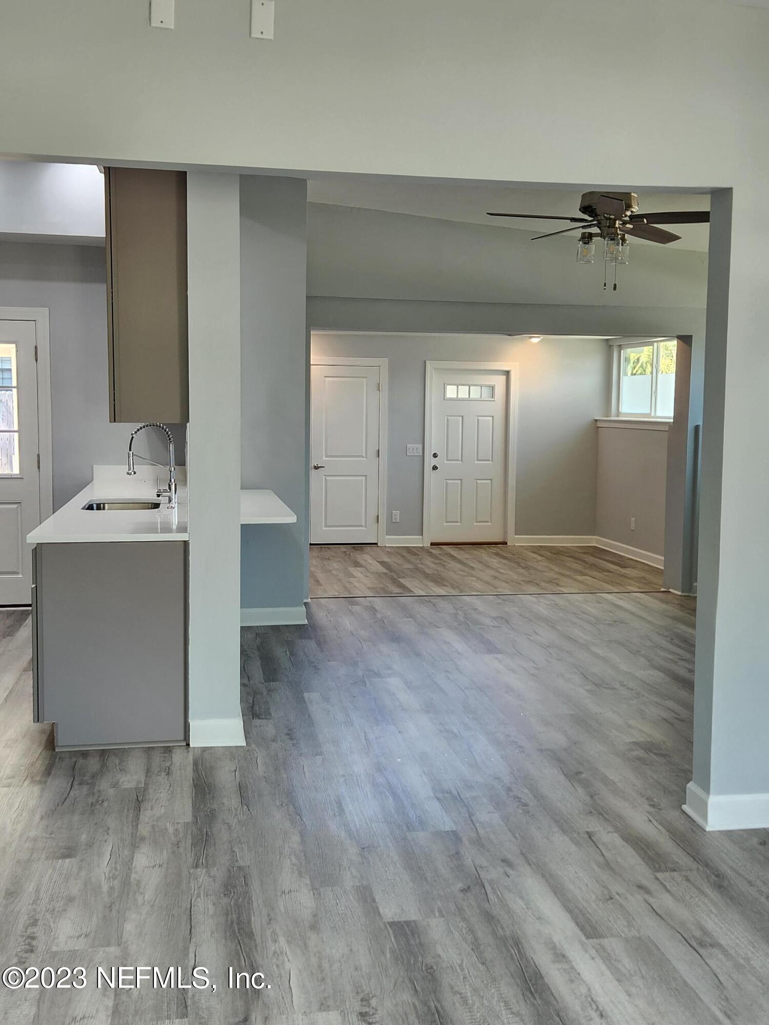 1306 Morgana Road Jacksonville, FL 32211 - Photo 8 of 33 a view of a hallway with wooden floor and a bathroom
