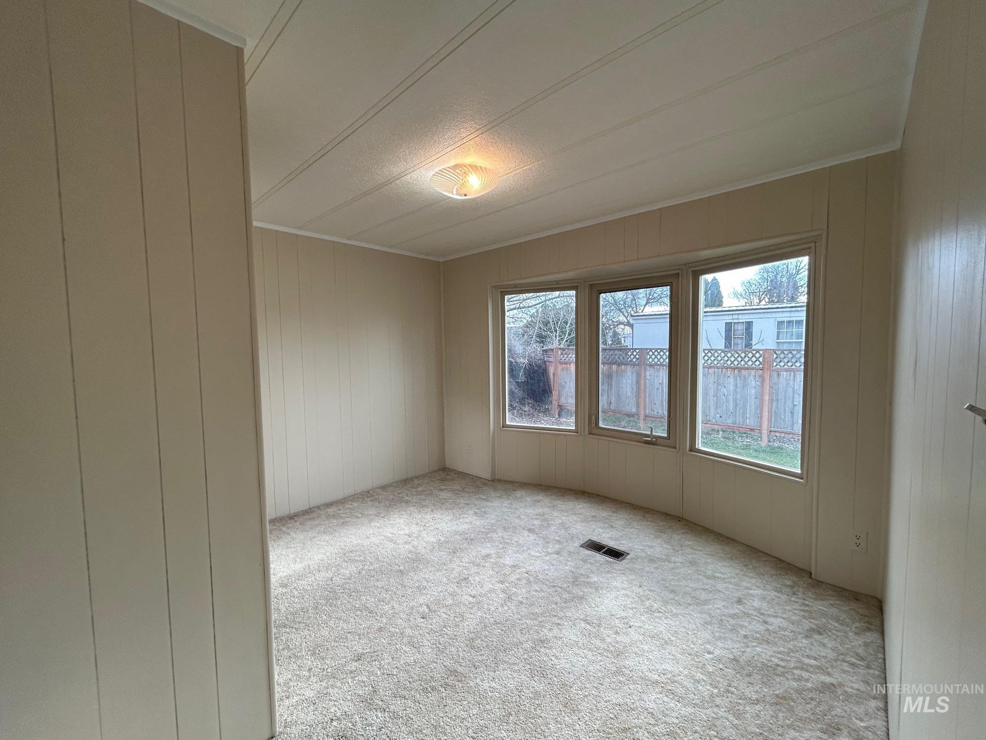 2015 6th Avenue, Unit 131A Clarkston, WA 99403 - Photo 15 of 26 Carpeted spare room featuring wooden walls