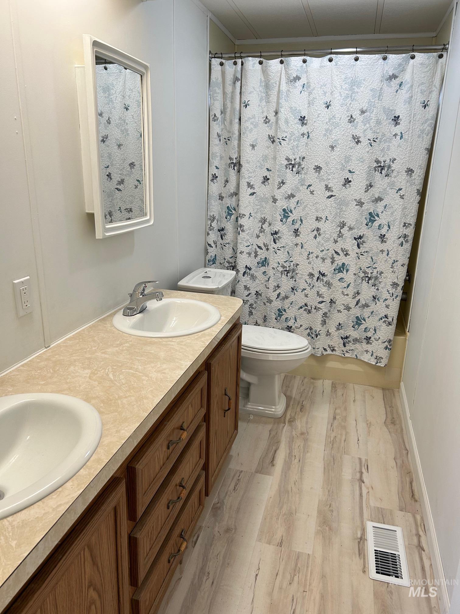2015 6th Avenue, Unit 131A Clarkston, WA 99403 - Photo 17 of 26 Bathroom with double vanity, light wood finished floors, and shower / bathtub combination with curtain