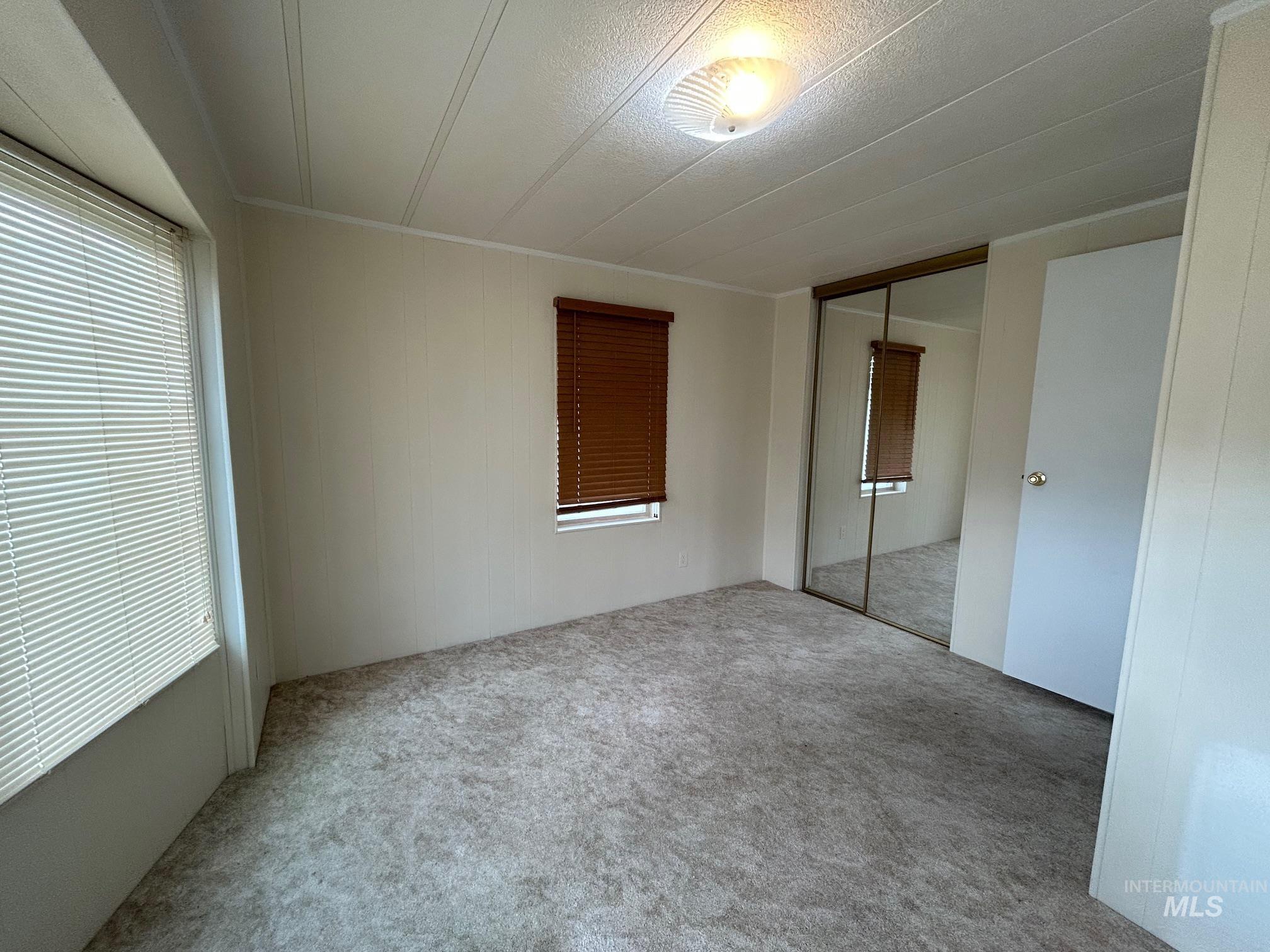 2015 6th Avenue, Unit 131A Clarkston, WA 99403 - Photo 19 of 26 Unfurnished bedroom with a closet, carpet floors, and multiple windows