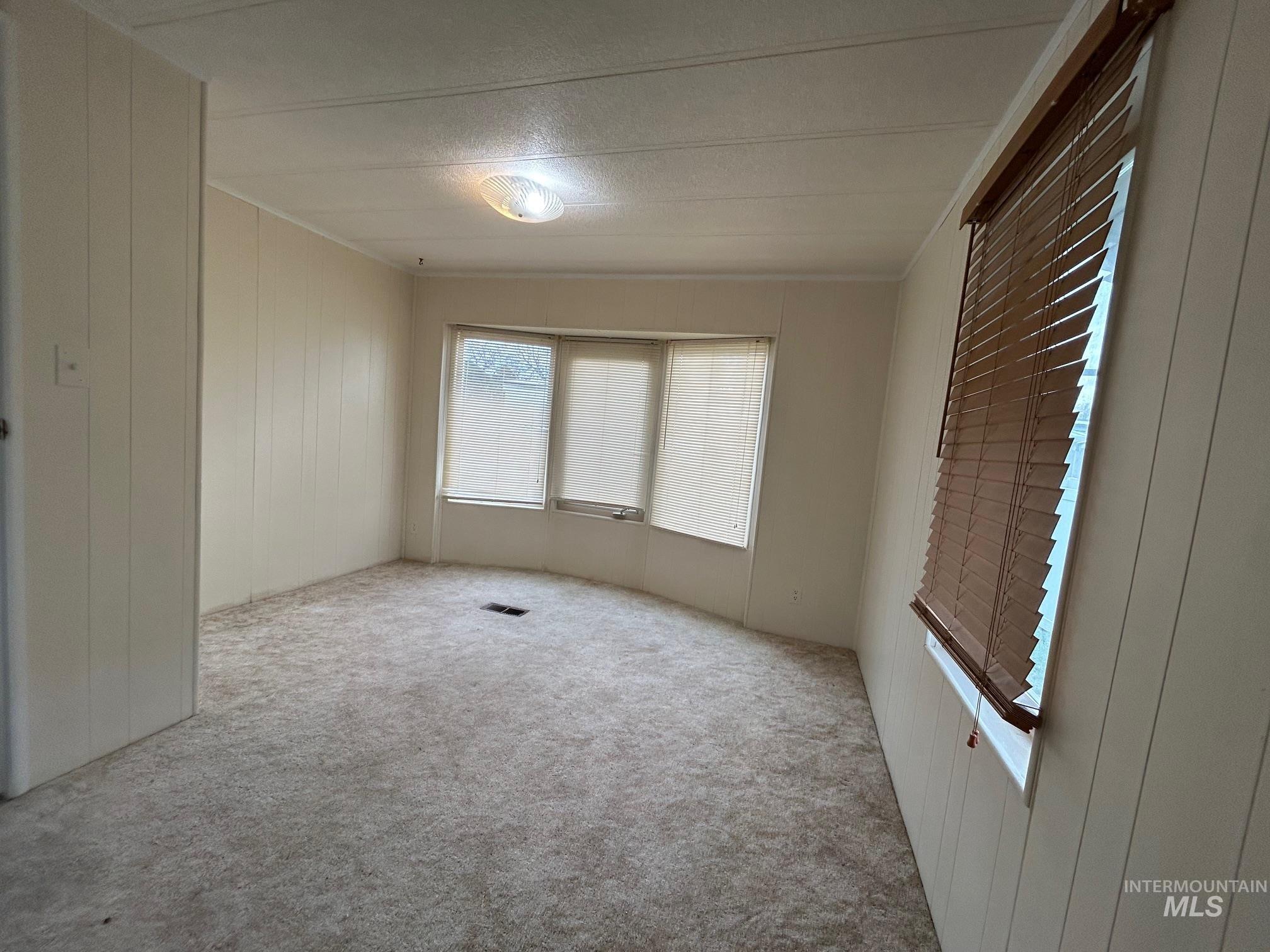 2015 6th Avenue, Unit 131A Clarkston, WA 99403 - Photo 20 of 26 Empty room featuring wood walls and carpet