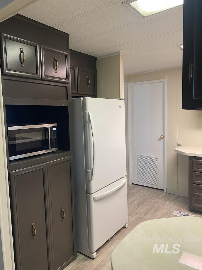 2015 6th Avenue, Unit 131A Clarkston, WA 99403 - Photo 5 of 13 Kitchen with freestanding refrigerator, light wood-style flooring and light countertops