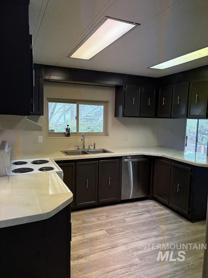 2015 6th Avenue, Unit 131A Clarkston, WA 99403 - Photo 8 of 26 Kitchen with white range with electric cooktop, light countertops, dark cabinetry, and dishwasher