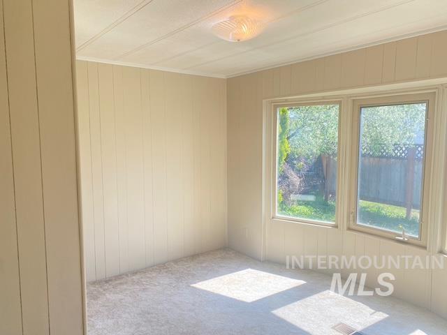 2015 6th Avenue, Unit 131A Clarkston, WA 99403 - Photo 10 of 13 Spare room with wood walls and carpet floors