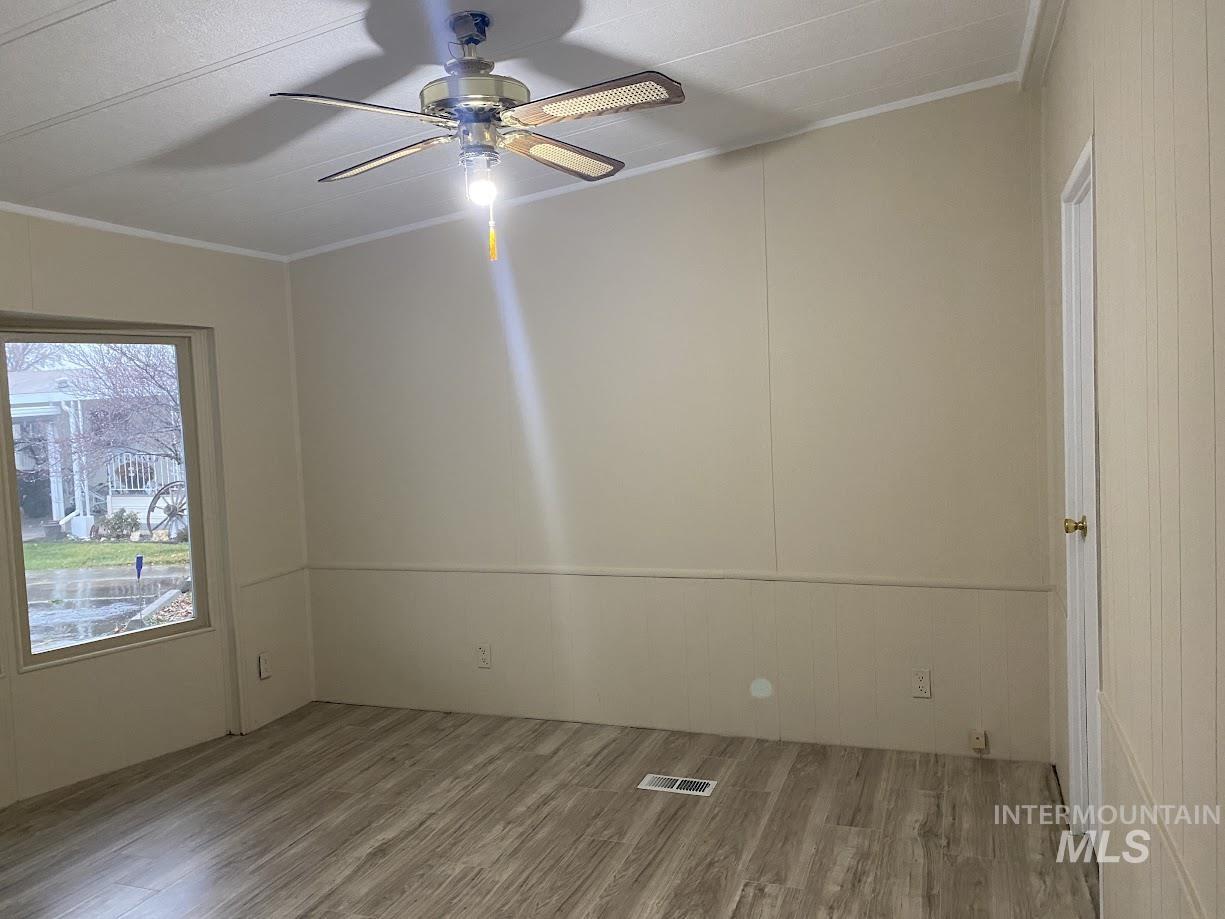 2015 6th Avenue, Unit 131A Clarkston, WA 99403 - Photo 10 of 26 Primary suite with light wood-type flooring, ornamental molding, a ceiling fan, and a decorative wall