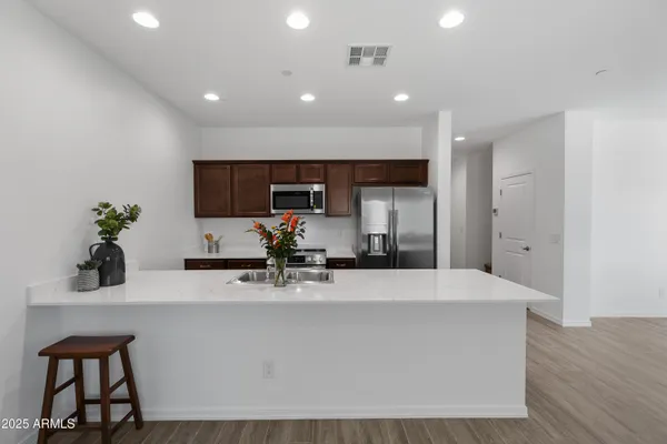 a view of kitchen with sink microwave and cabinets