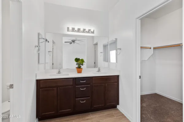 a spacious bathroom with a sink and a mirror