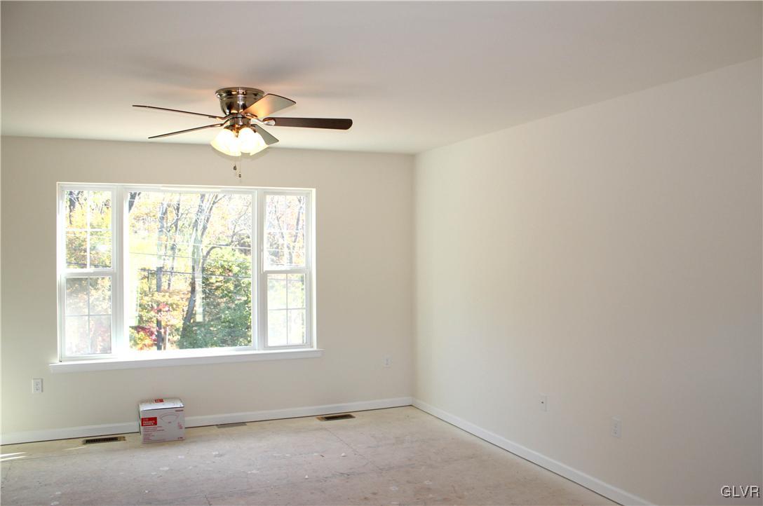 437 English Road Bath, PA 18014 - Photo 8 of 11 an empty room with windows and fan