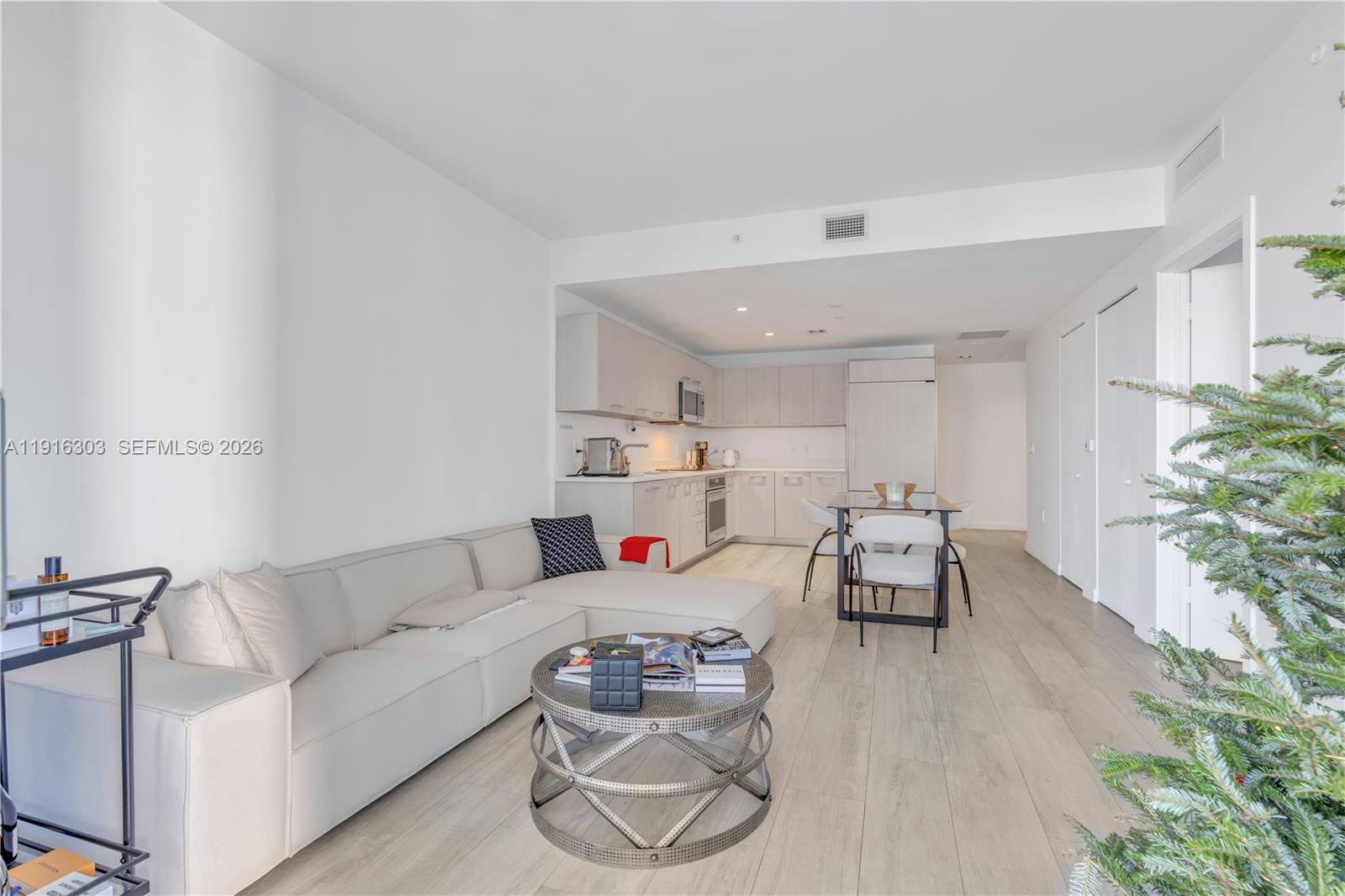 55 Southwest 9th Street, Unit 2610 Miami, FL 33130 - Photo 2 of 21 a living room with furniture and flowers