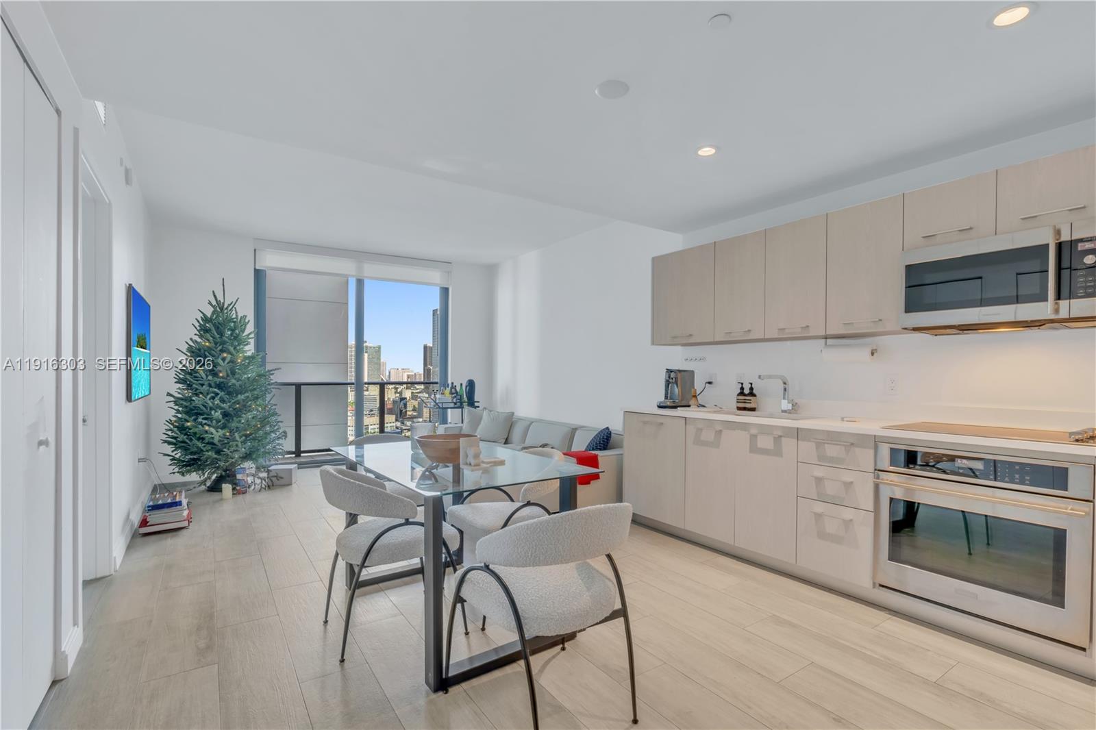 55 Southwest 9th Street, Unit 2610 Miami, FL 33130 - Photo 3 of 21 a kitchen with a table and chairs in it