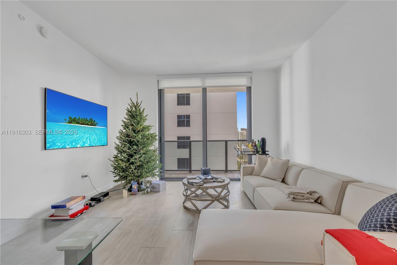 55 Southwest 9th Street, Unit 2610 Miami, FL 33130 - Photo 4 of 21 a living room with furniture and a potted plant
