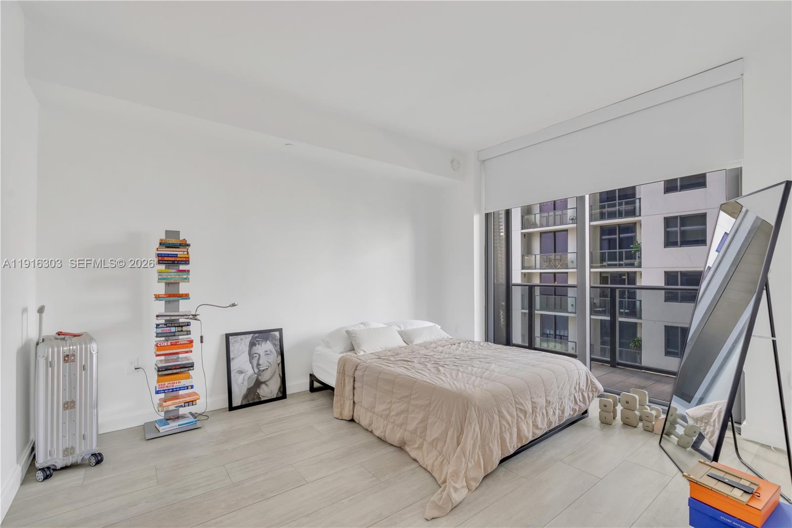 55 Southwest 9th Street, Unit 2610 Miami, FL 33130 - Photo 8 of 21 a bedroom with a bed and a book shelf