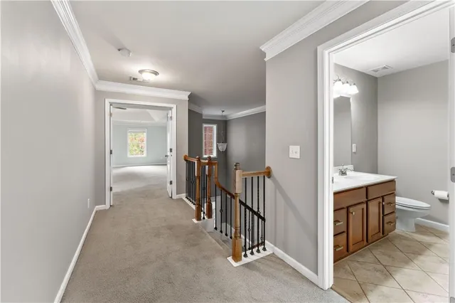 a view of a hallway view with three rooms