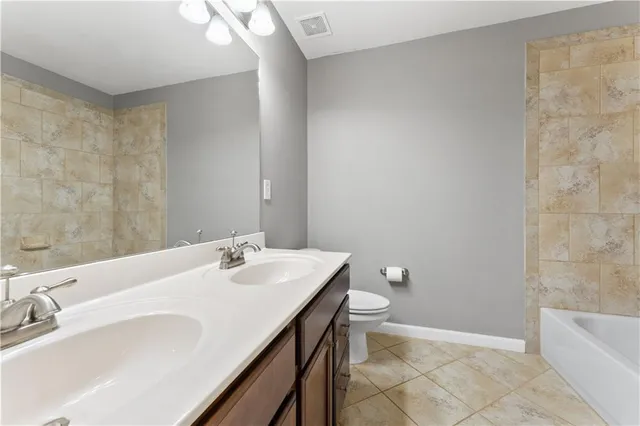 a bathroom with a sink a toilet and bathtub