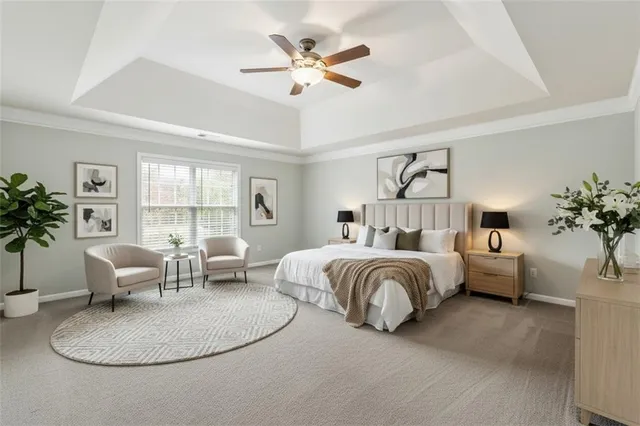 a bedroom with bed couch and window