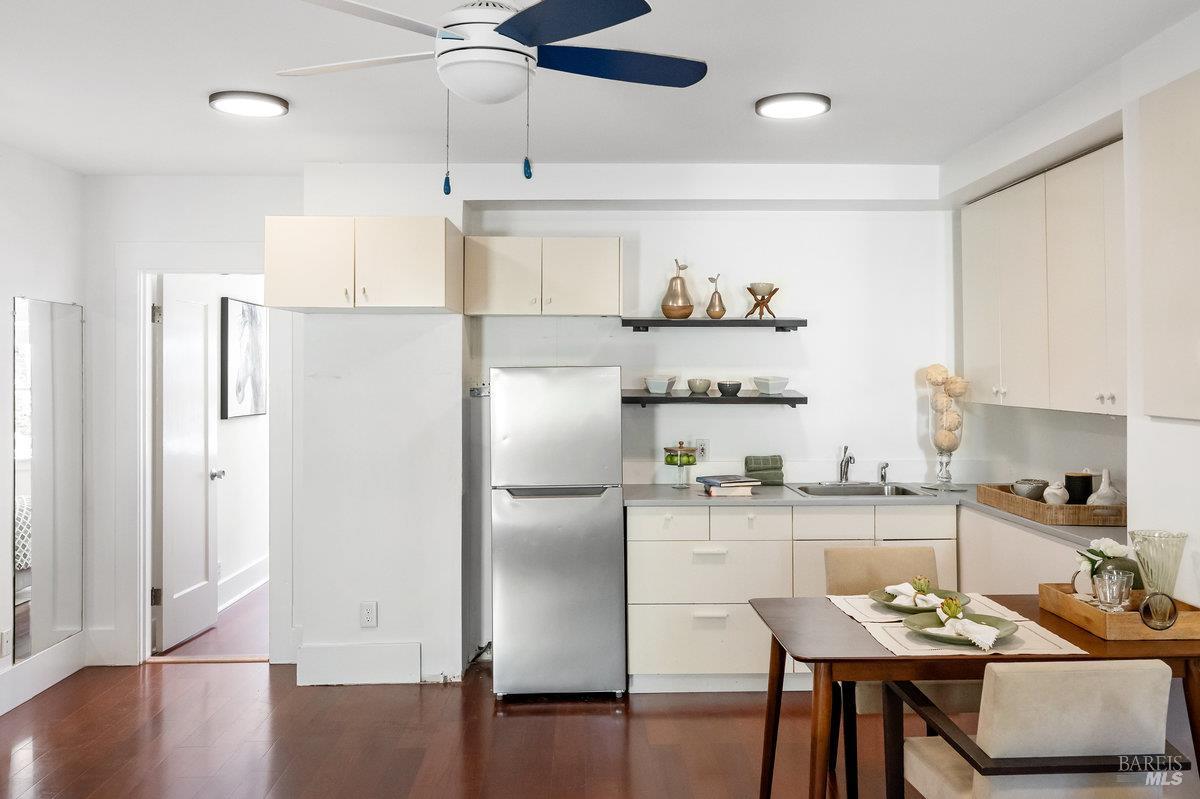 338 Paloma Avenue San Rafael, CA 94901 - Photo 23 of 31 a kitchen with stainless steel appliances granite countertop a refrigerator a sink a stove and chairs with wooden floor