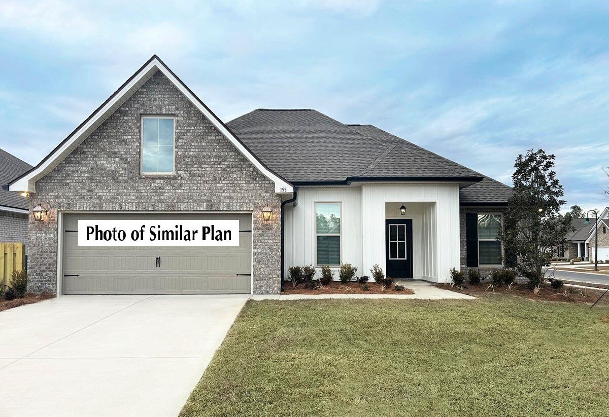 331 East Tweet Street Freeport, FL 32439 - Photo 1 of 3 a front view of a house with a yard and garage
