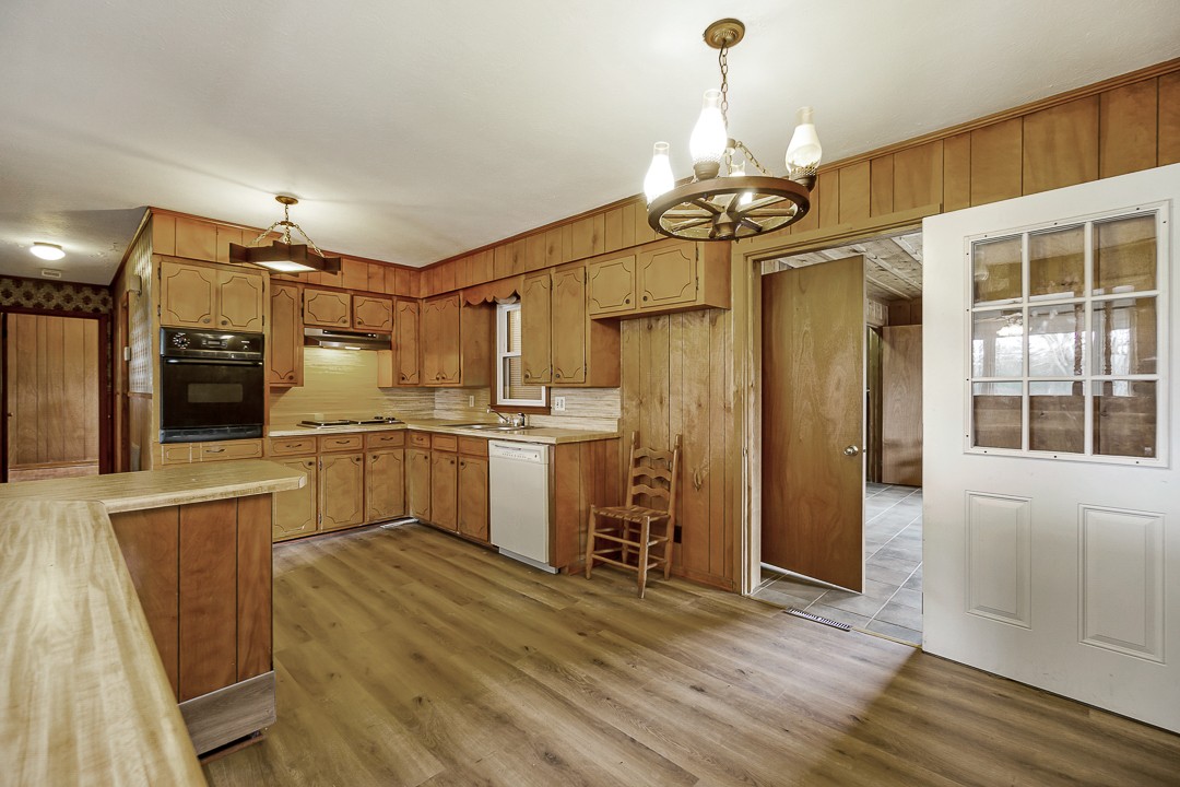 229 County House Road Sparta, TN 38583 - Photo 12 of 33 a kitchen with refrigerator cabinets and wooden floor