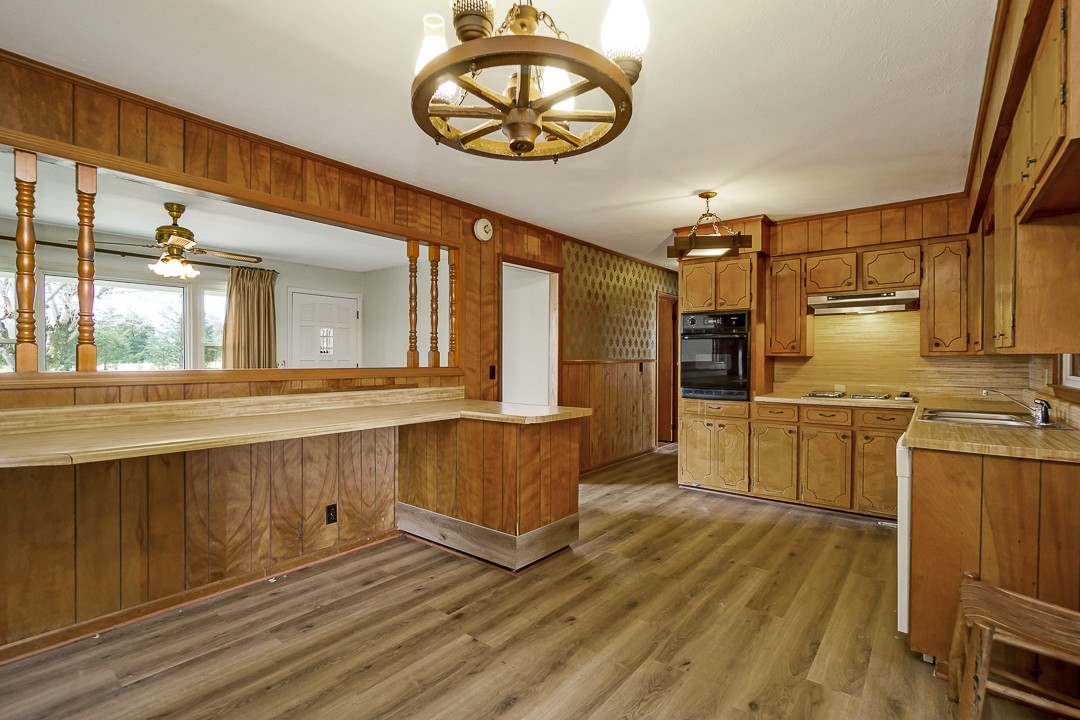 229 County House Road Sparta, TN 38583 - Photo 13 of 33 a kitchen with stainless steel appliances a stove cabinets and a wooden floor