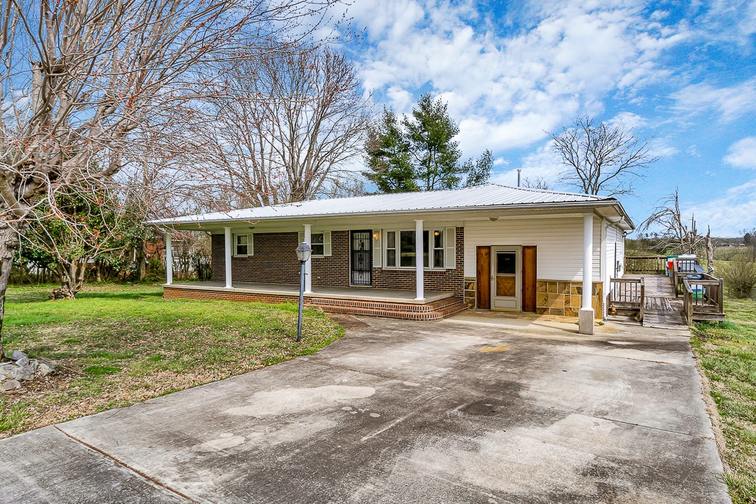 229 County House Road Sparta, TN 38583 - Photo 5 of 33 a front view of a house with a yard and trees