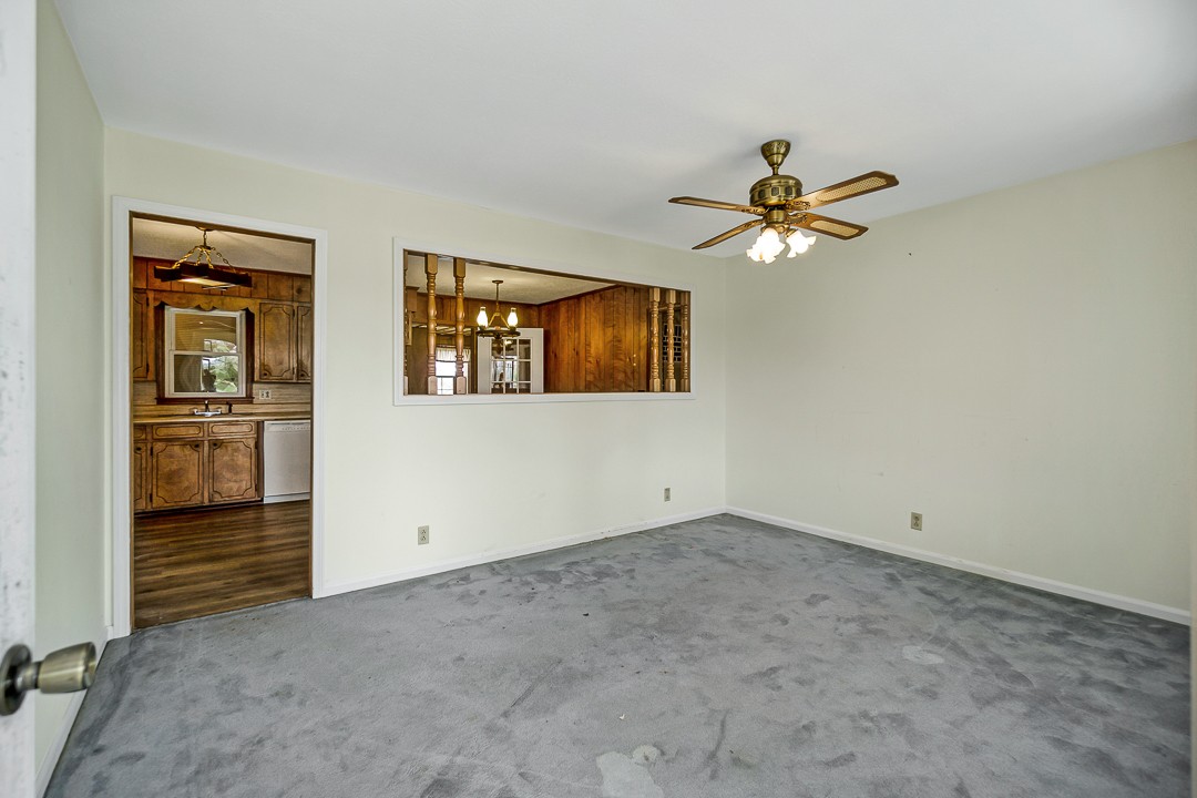 229 County House Road Sparta, TN 38583 - Photo 7 of 33 an empty room with chandelier fan and windows