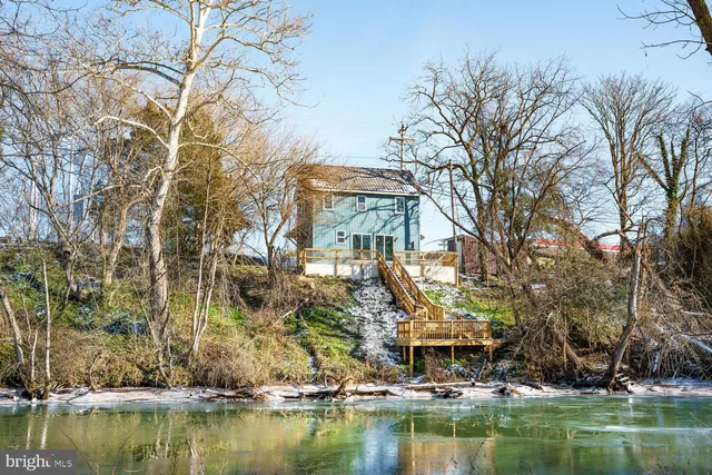 a front view of a house with a lake view