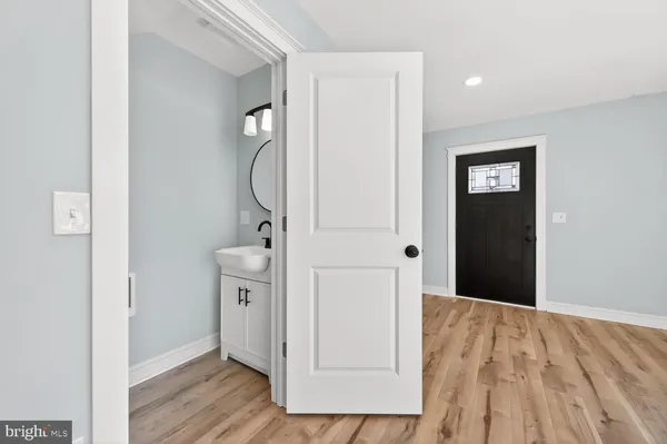 a view of a hallway with closet and wooden floor