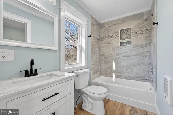 a bathroom with a sink a toilet and a bathtub