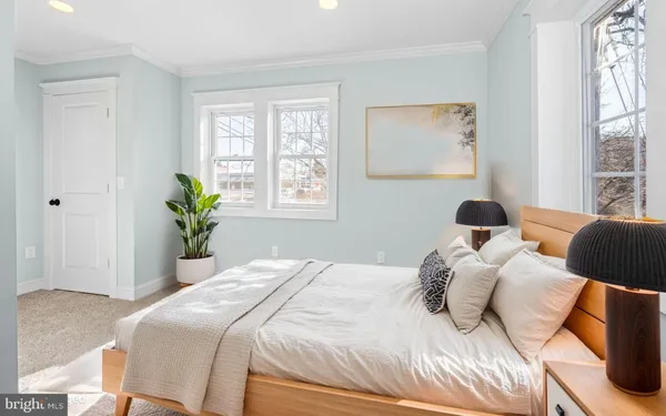 a bedroom with a bed running cycle and a window
