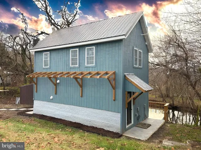 a view of a house with a wooden fence