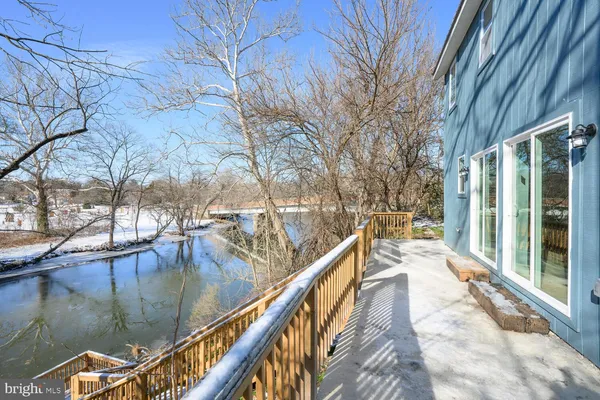 a view of balcony with wooden floor and lake view