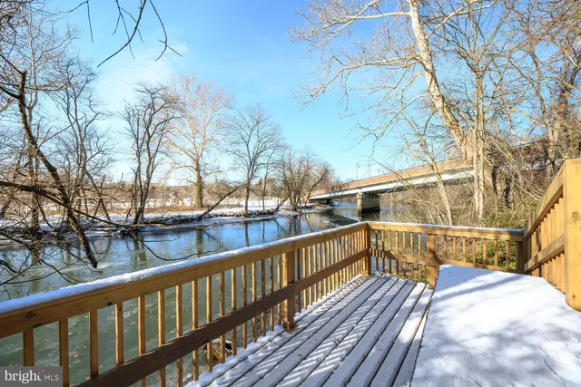 a view of balcony with wooden floor and fence