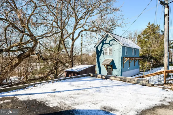 a view of a house with snow on the road