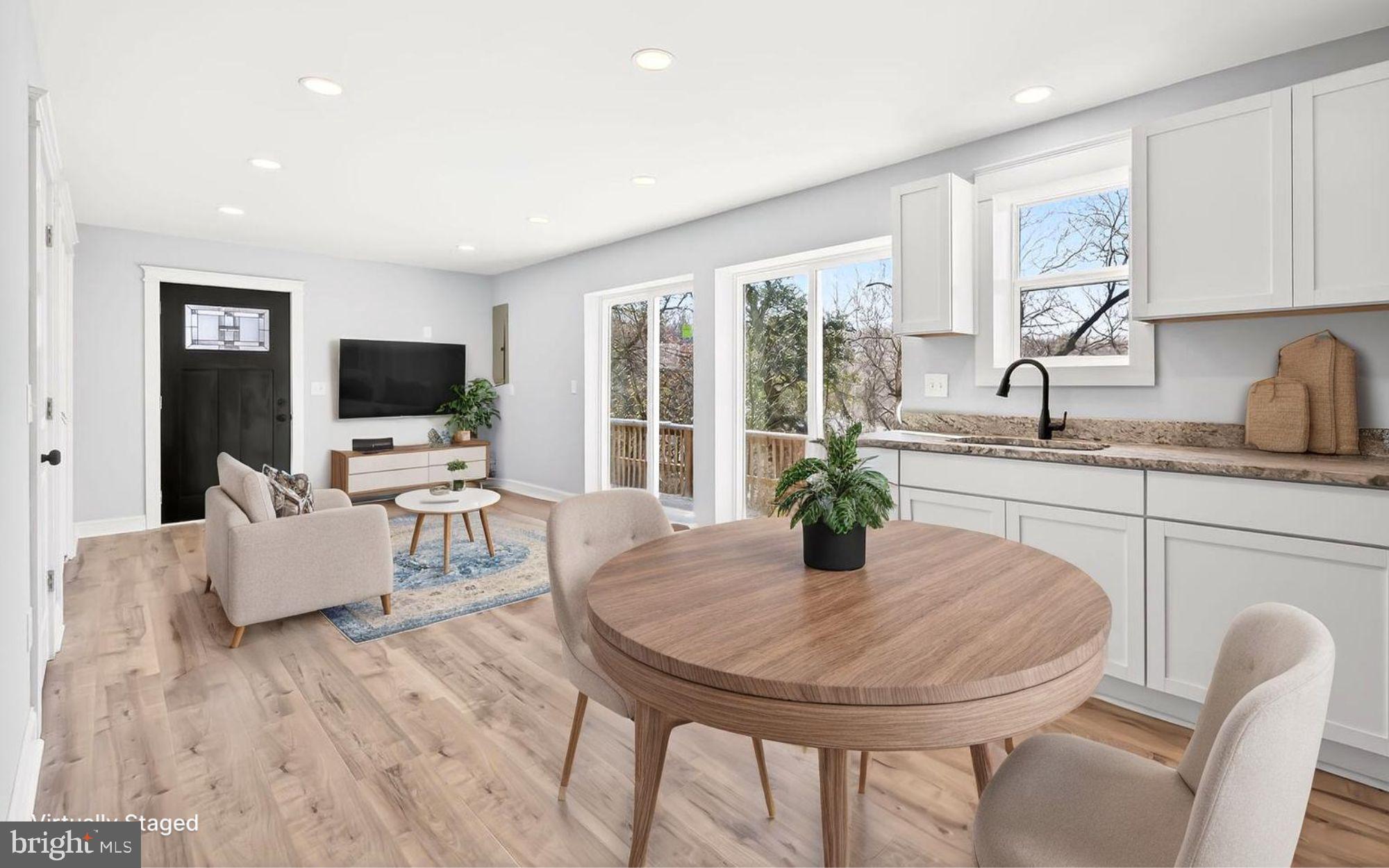 13306 Greensboro Road Greensboro, MD 21639 - Photo 5 of 48 a kitchen with a table chairs and flat screen tv