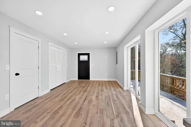 a view of hallway with a large window and wooden floor