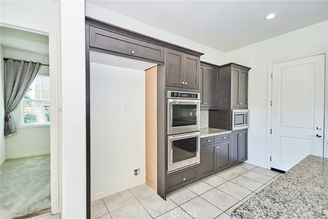 a kitchen with stainless steel appliances granite countertop a refrigerator and cabinets