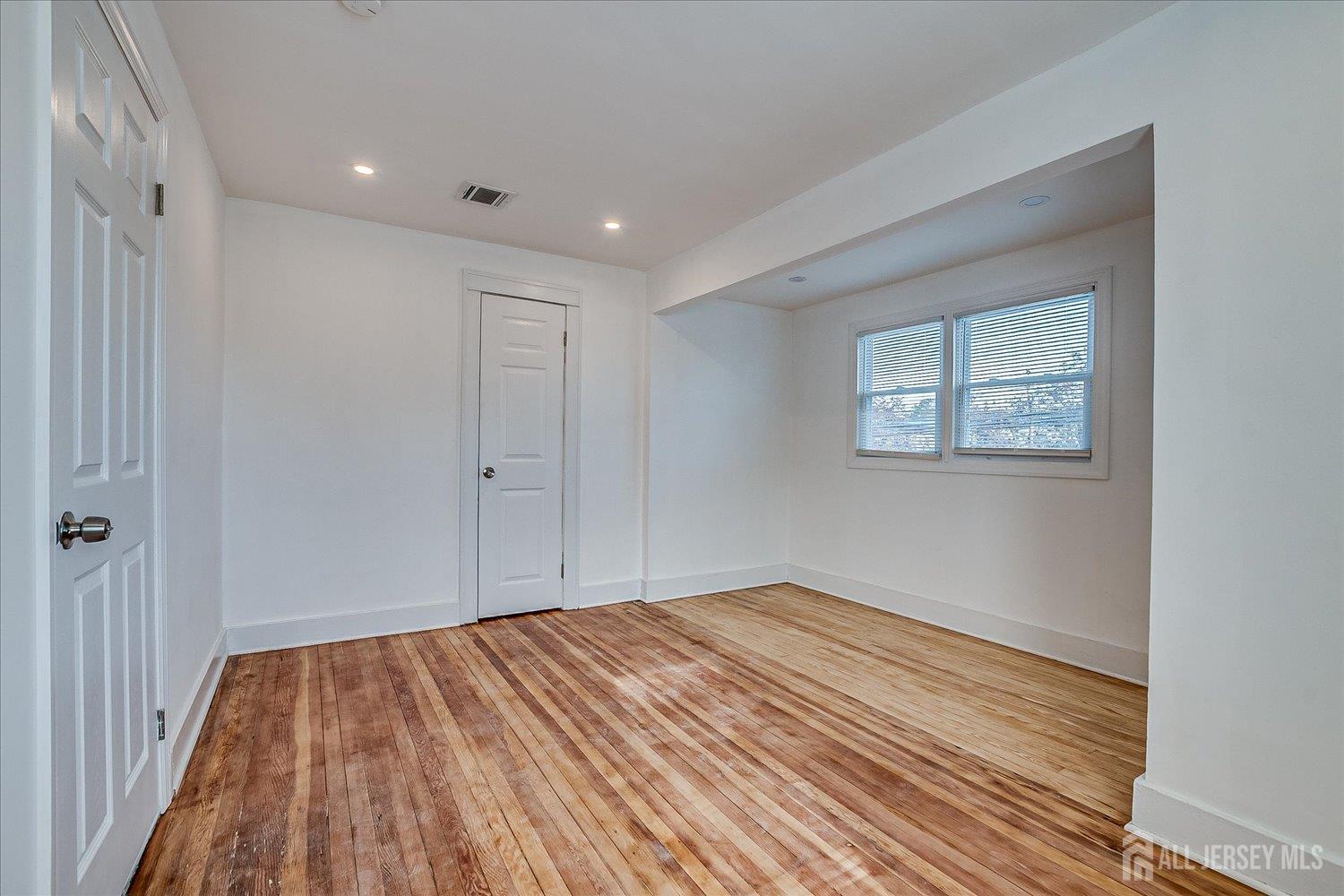 385 Pierson Avenue, Unit 2 Edison, NJ 08837 - Photo 13 of 18 a view of empty room with wooden floor