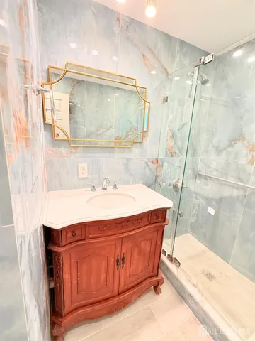 a bathroom with a shower sink and toilet